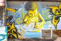 Graffiti painting of a kid studying.